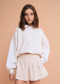 Cheerful white kid wearing blank white embroidered polo sweatshirt and white contrast pleated skirt miniskirt sleeve blouse.