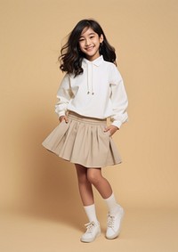 Cheerful asian kid wearing blank white embroidered polo sweatshirt and white contrast pleated skirt miniskirt child hairstyle.