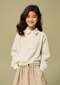 Cheerful asian kid wearing blank white embroidered polo sweatshirt and white contrast pleated skirt sleeve blouse smile.