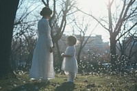 Mother and child standing outdoors wedding.