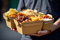 Delivery man is carrying food container snack.