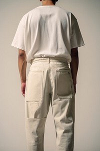Close up man wearing vintage bottom jeans with empty embroider label on back side fashion pants adult.