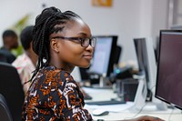 African working woman using computer electronics accessories dreadlocks.