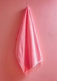 Rectangle white empty label suture on pink towel hanging simplicity coathanger clothing.