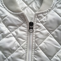 Empty white label tag printing inside neck lightweight quilted gilet jacket zipper backgrounds.