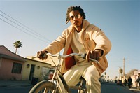 Young black man riding lowrider bike portrait cycling bicycle.