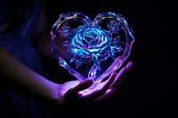 Neon heart and rose in hand light adult illuminated.