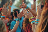 A group of friends wearing Solza silicone wristbands at a music festival celebration atmosphere bracelet.