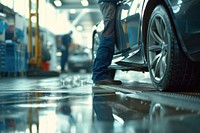 Engineer checking car on ramp in car service architecture vehicle wheel.