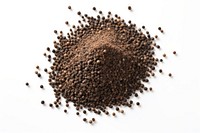 Ground black pepper flakes seed soil white background.