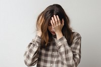 Woman doing facepalm worried anxiety pain.