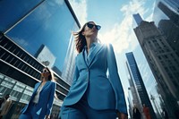 Businesswomen walking down a busy city street architecture sunglasses photo.