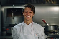 Male chef smilling in the kitchen adult men restaurant.