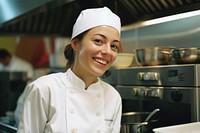 Female chef smilling in the kitchen adult restaurant happiness.