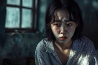Korean Young female crying at funaral worried adult contemplation.