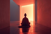 A person in a robe sitting in a room light spirituality architecture.