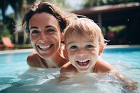 Mother and toddler swimming smile laughing.