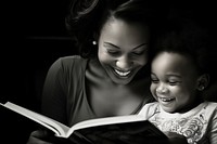 Mother and toddler reading book publication.