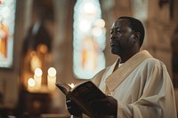 African american priest praying in church candle adult spirituality.