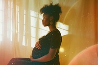 Black woman pregnant light leaks adult contemplation anticipation.