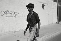 Black man Rapper sunglasses portrait walking.