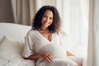 Pregnant woman smiling sitting smile.