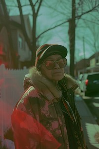 Old woman wearing metalic streetwear clothes architecture portrait outdoors.