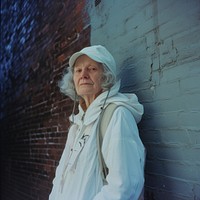 Old woman wearing white streetwear clothes portrait adult photo.