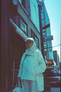 Old woman wearing white streetwear clothes adult city transportation.