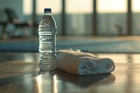 Water bottle and white towel refreshment relaxation drinkware.