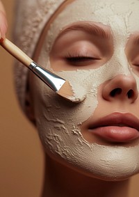 Woman applying facial mask cosmetics adult skin.