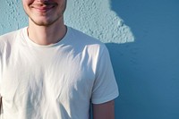 A happy man wearing white t shirt t-shirt sleeve blue.