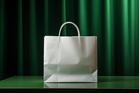 Paper shopping bag handbag green white.