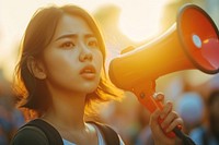Young asian woman using megaphone adult performance hairstyle.