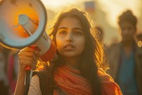 Young indian woman using megaphone portrait photo photography.