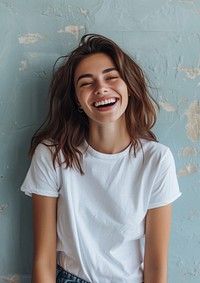 A happy woman wearing white t shirt laughing smile blue.
