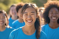 Happy mixed race asian women volunteer laughing outdoors.