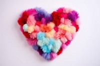 Heart shape pom pom rug toy white background celebration.