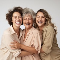 Three diverse women in different ages laughing adult smile.
