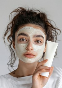 A Young woman with organic mask portrait holding adult.