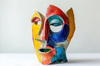 One piece of colorful ceramic art made by kid mask representation creativity.