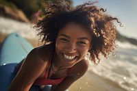 Black girl surfer surfing laughing swimwear portrait.