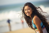 Korean girl surfer surfing laughing portrait smiling.