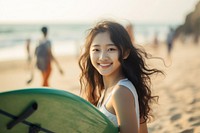 Korean girl surfer surfing portrait outdoors smiling.