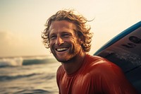 Surfer surfing laughing portrait outdoors.
