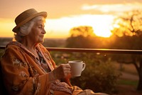 Elderly woman sunrise outdoors sitting.