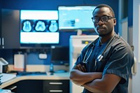 A black radiology technician standing in front a workstation computer glasses adult.