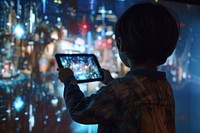 A kid holding a tablet and interact with metaverse technology photography computer architecture.