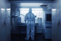 A radiology technician wear a protective suit standing in front a x-ray station laboratory hospital adult.