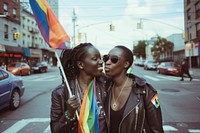 Black couple lesbian woman with gay pride flag on the street city road transportation.